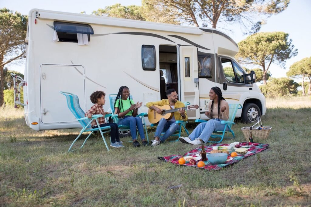 Familien-Wohnmobil mit ausgefahrener Markise und Campingtisch, der die Wichtigkeit des Outdoor-Mobiliars zeigt.